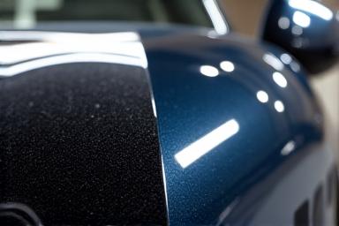 A 50/50 shot of a car panel showing corrected vs uncorrected paint.